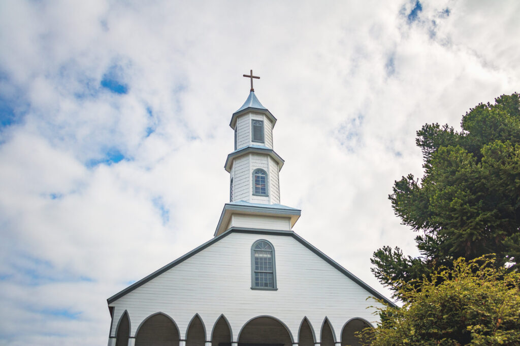 White church with a steeple against blue sky backdrop