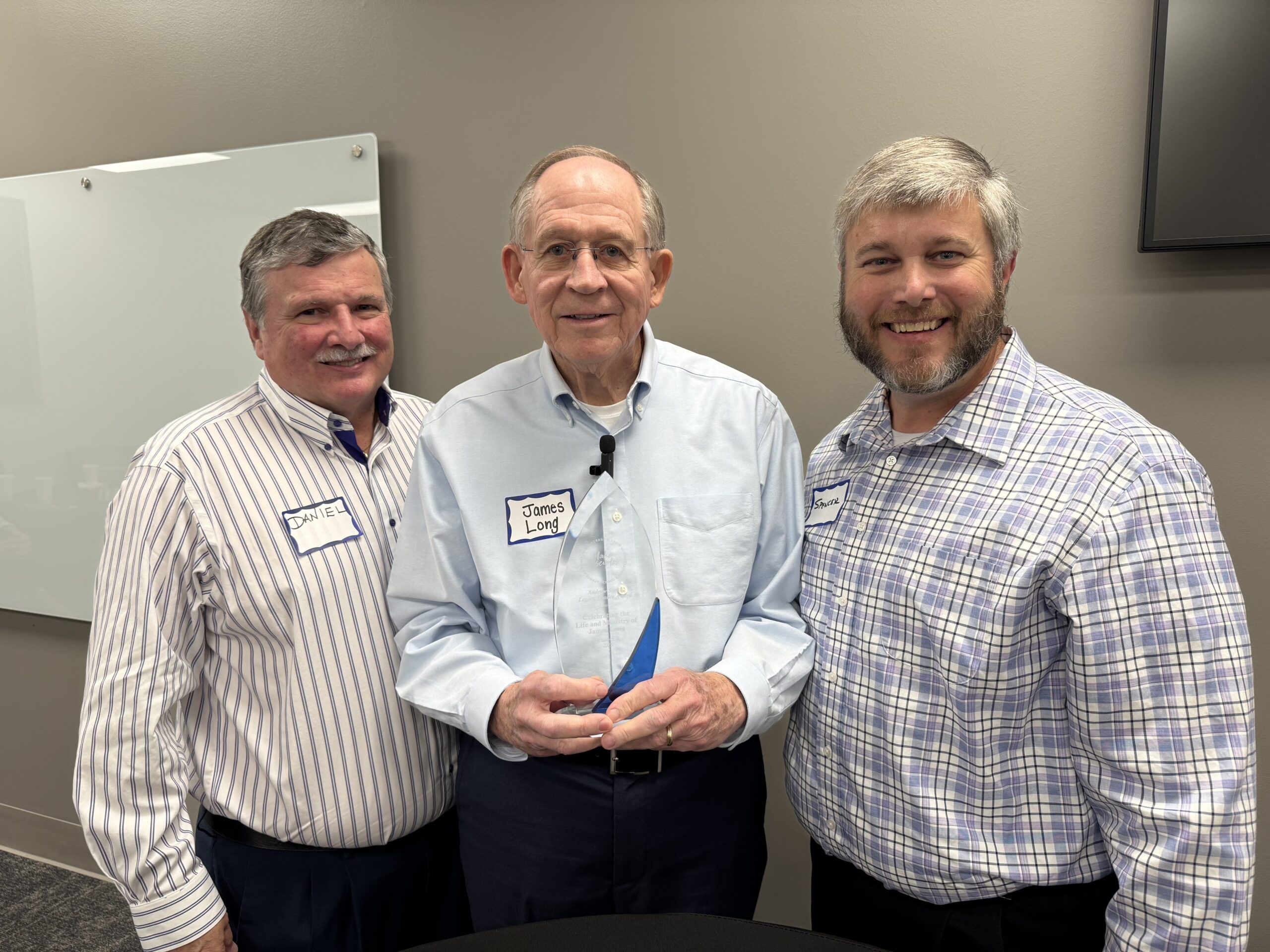 Daniel Edmonds, James Long (holding award), and Spencer Knight